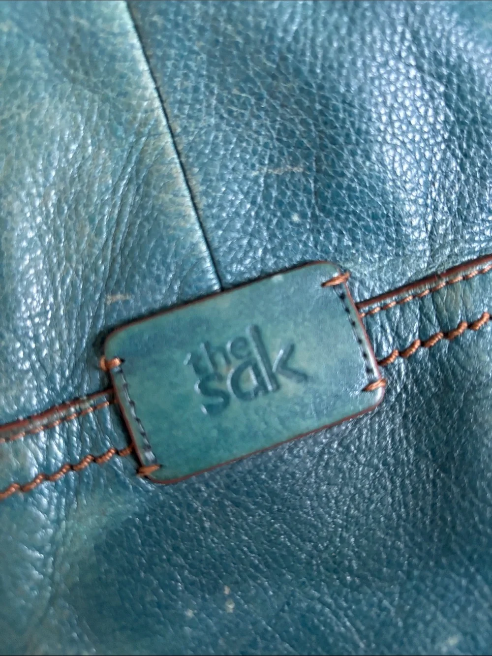 The Sak Teal Leather Shoulder Bag distressed has been loved and used.